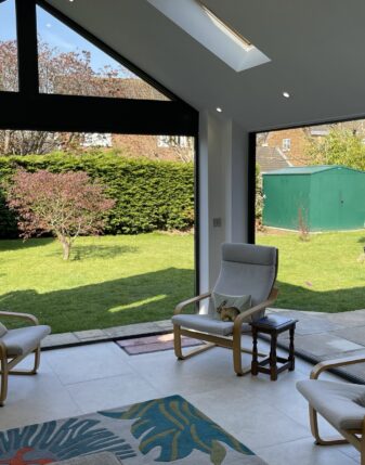 This conservatory project features a set of wide UPVC windows encased in a sleek frame.